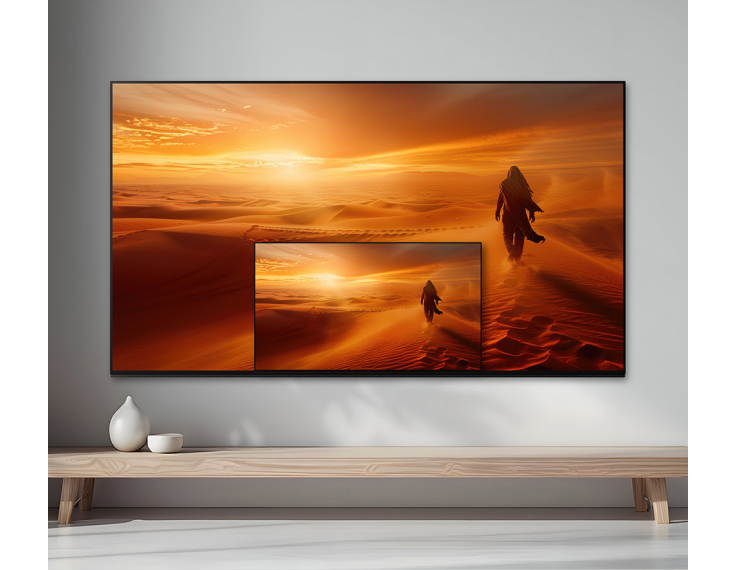 Wall-mounted TV displaying a desert scene, with a smaller picture-in-picture window shown on the screen.