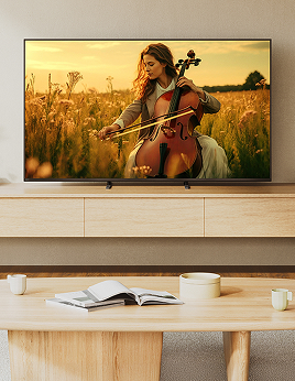 BRAVIA 5 TV displaying a musician playing a cello in a golden field, set in a modern living room.