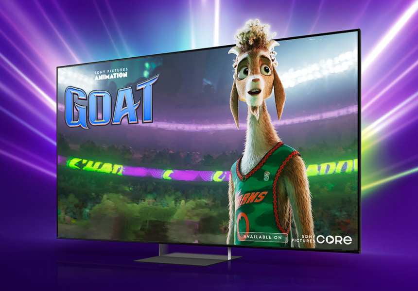 Promotional title card for the Sony Pictures Animation film GOAT on a TV screen, featuring an animated goat basketball player in a green jersey, set against a vibrant purple backdrop.